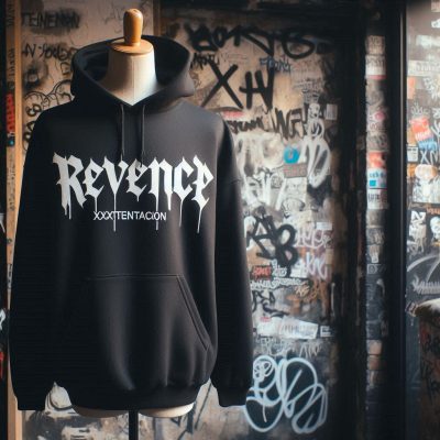 Model in black XXXTentacion Revenge hoodie in front of urban mural